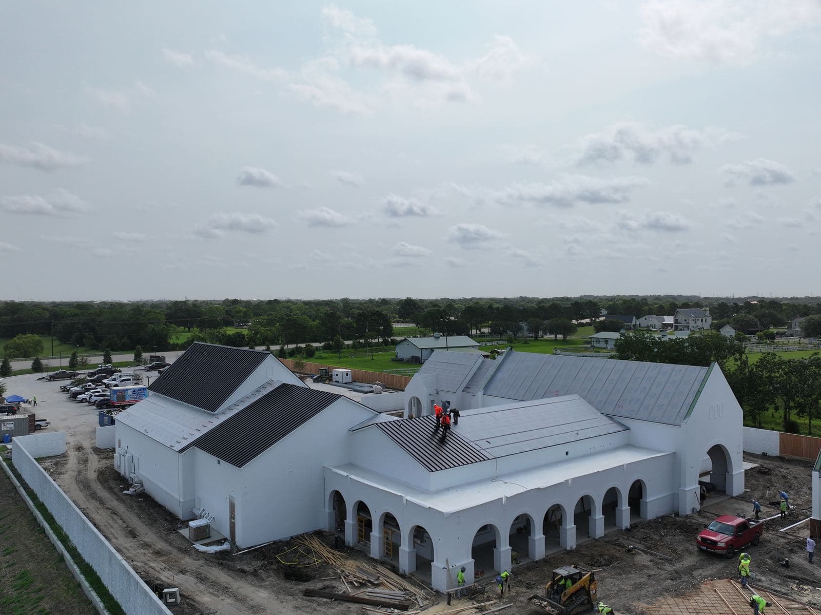 Crew Installing Metal Roof · Aerial