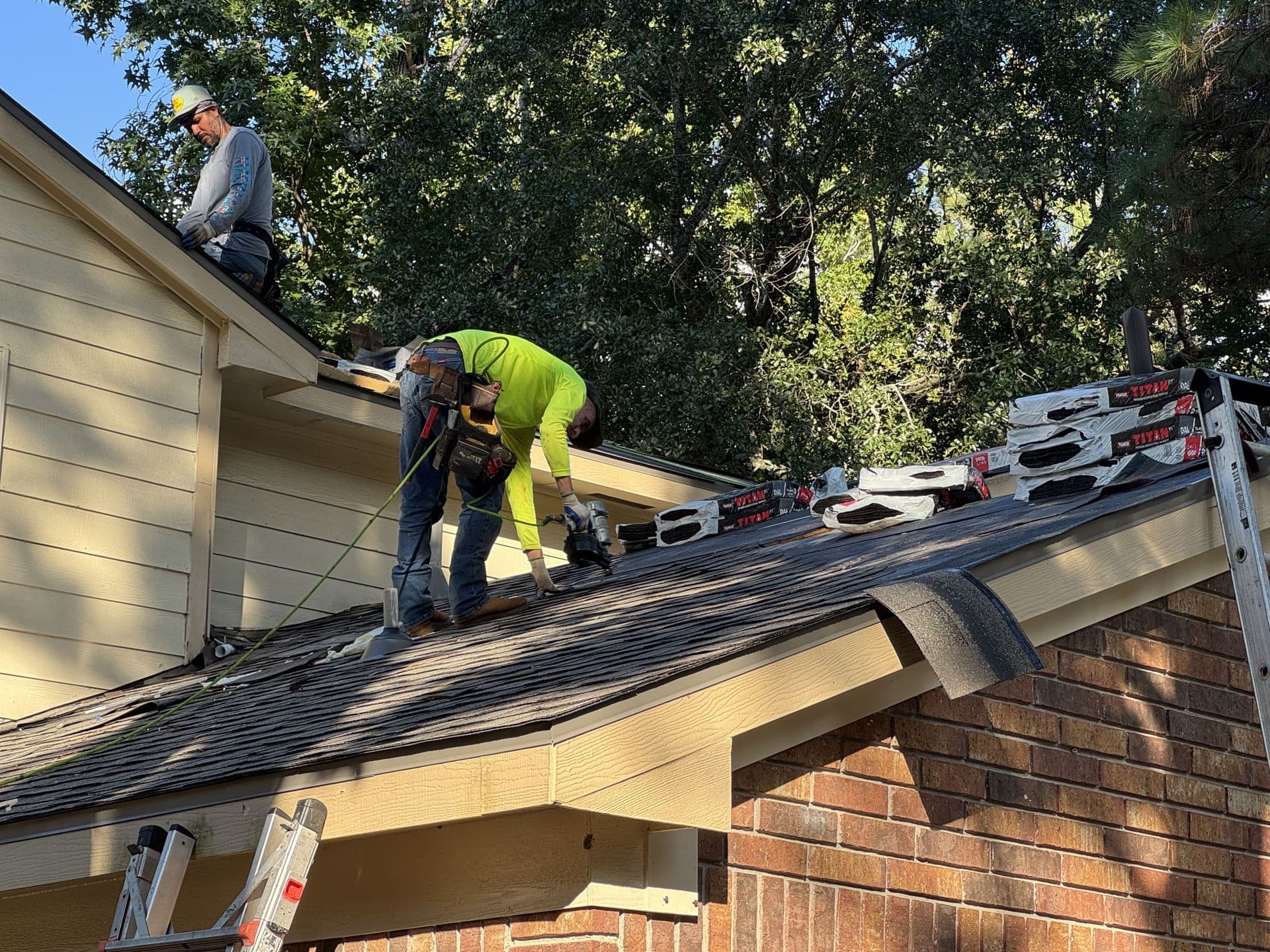 Crew Shingling a Roof Edge